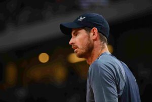 Andy Murray looks focused during a match at the Stuttgart Open, wearing a navy cap and a grey shirt."